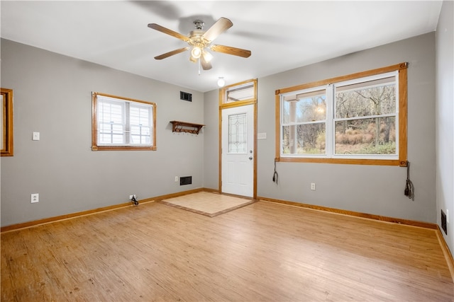 foyer entrance featuring ceiling fan, plenty of natural light, and light hardwood / wood-style floors