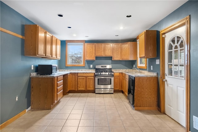 kitchen with stainless steel range with gas cooktop, sink, dishwasher, and light tile patterned floors