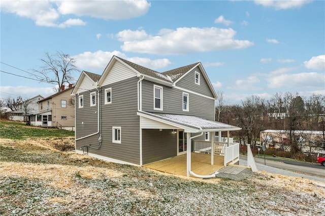 view of side of home with covered porch