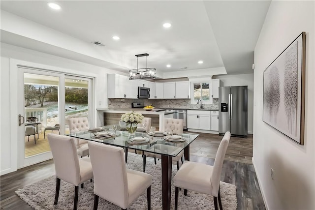 dining area with dark hardwood / wood-style flooring and sink