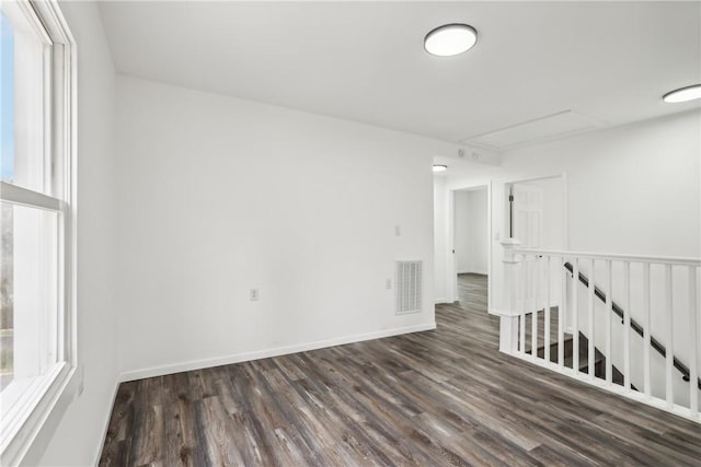 spare room featuring dark wood-type flooring