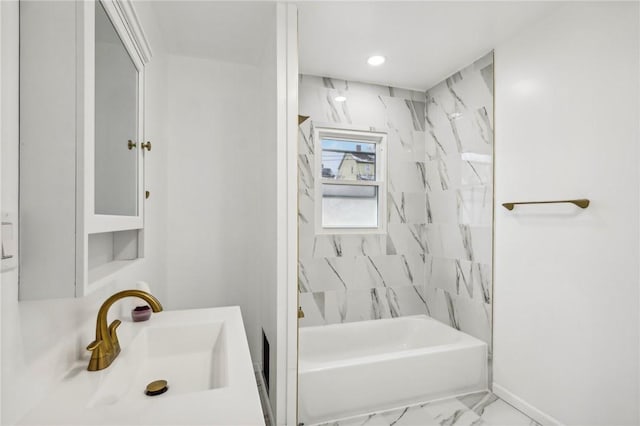 bathroom featuring vanity and tiled shower / bath