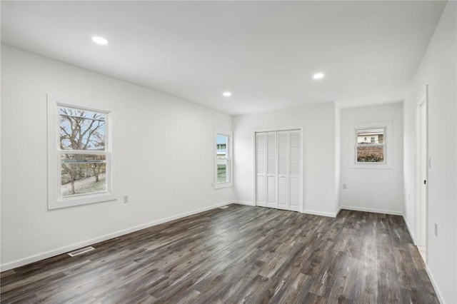 unfurnished bedroom with dark hardwood / wood-style floors