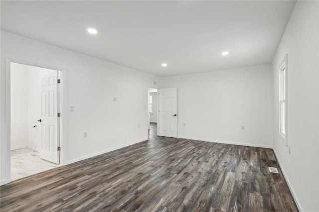 spare room with dark hardwood / wood-style floors