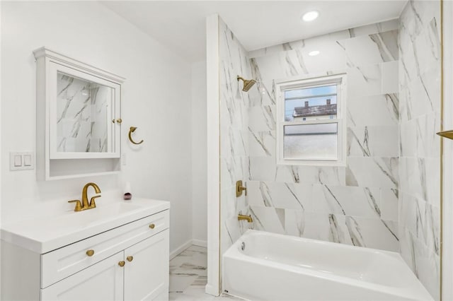 bathroom featuring vanity and tiled shower / bath