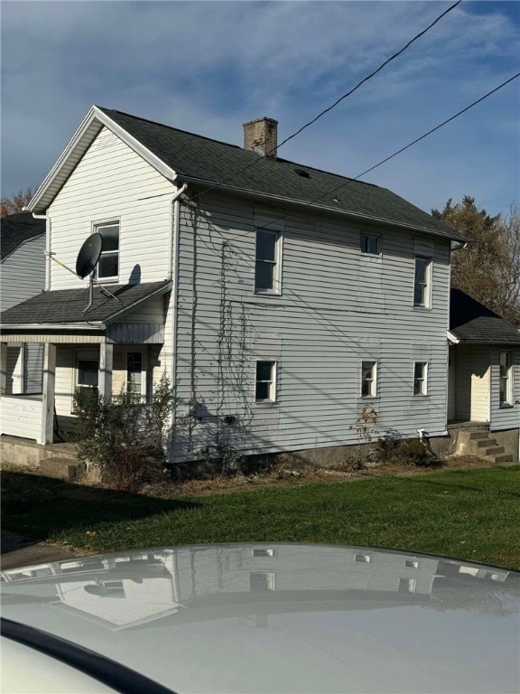 view of property exterior with a lawn