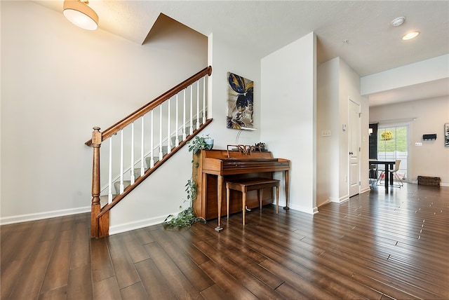 entrance foyer featuring a textured ceiling and dark wood-type flooring