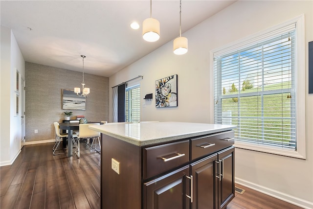 kitchen with dark hardwood / wood-style flooring, hanging light fixtures, and a healthy amount of sunlight