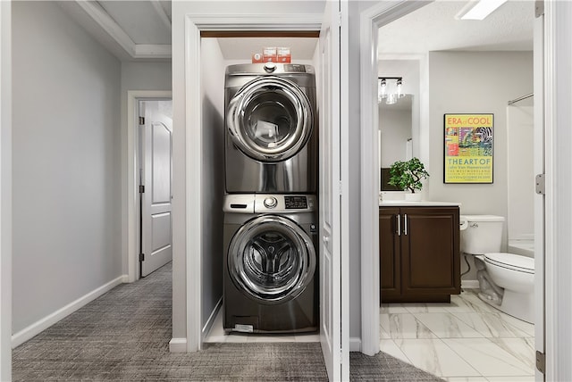 laundry area featuring stacked washer / dryer