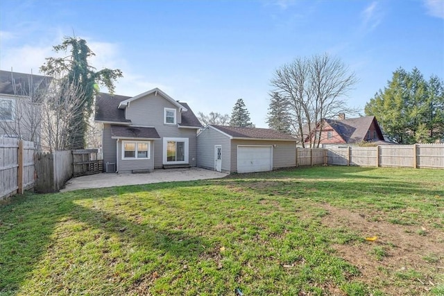 back of house featuring a yard, a patio, and a garage