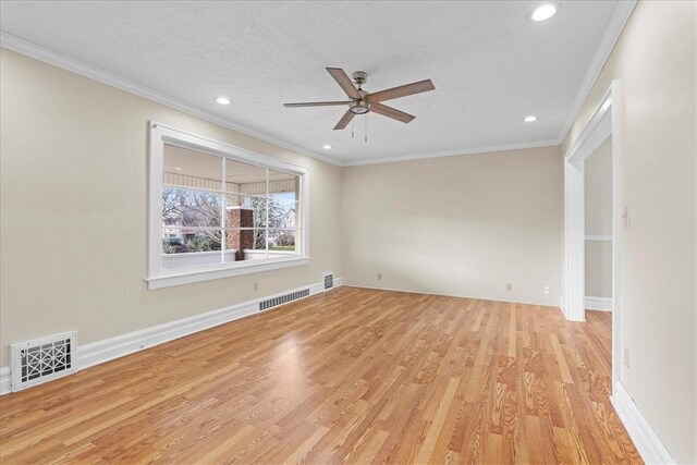 unfurnished room featuring ceiling fan, ornamental molding, a textured ceiling, and light hardwood / wood-style flooring