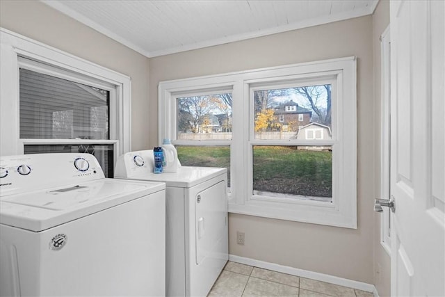 washroom featuring light tile patterned floors and washer and clothes dryer