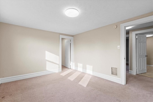 carpeted spare room featuring a textured ceiling