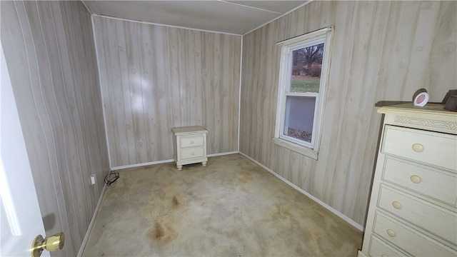 empty room featuring wooden walls and light carpet