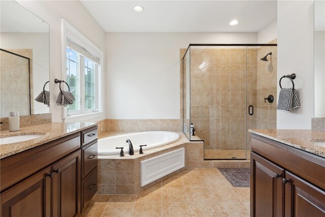 bathroom with tile patterned flooring, vanity, and shower with separate bathtub