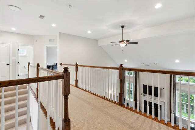 hall featuring light carpet and vaulted ceiling