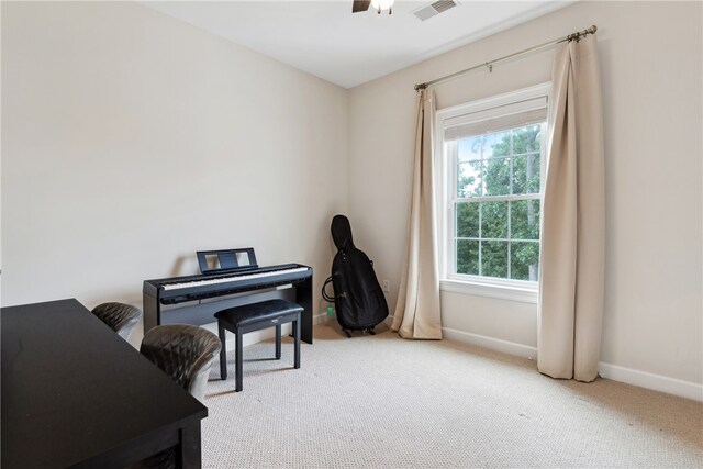 miscellaneous room with ceiling fan and light colored carpet