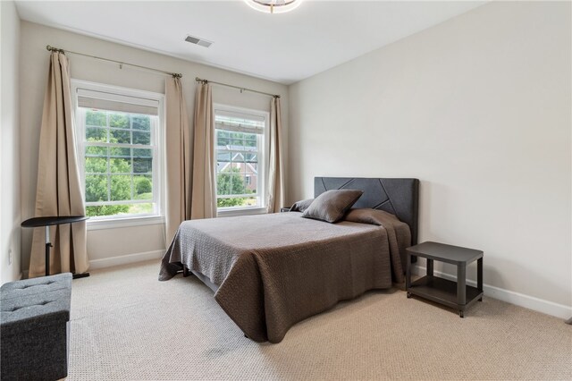 bedroom featuring light colored carpet