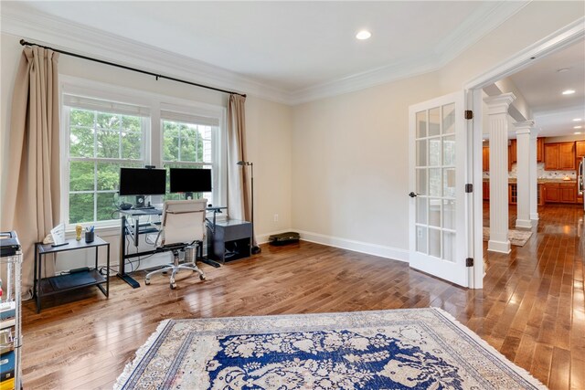 office space with wood-type flooring and ornamental molding