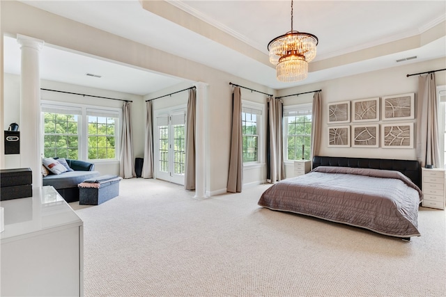 carpeted bedroom with a tray ceiling, an inviting chandelier, multiple windows, and crown molding