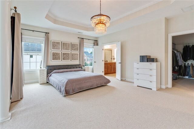 carpeted bedroom featuring ensuite bathroom, an inviting chandelier, a raised ceiling, and multiple windows