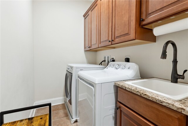 washroom featuring cabinets, light tile patterned floors, separate washer and dryer, and sink