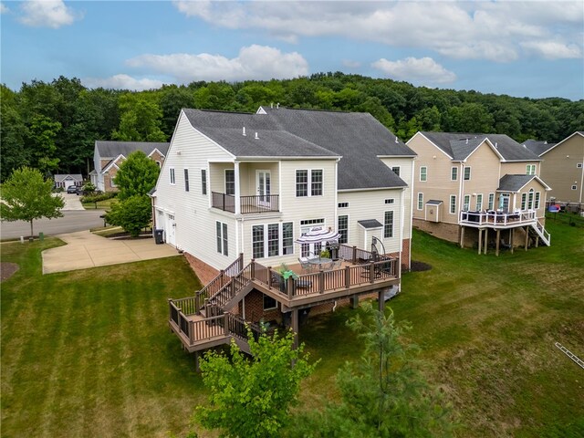 rear view of house with central air condition unit, a yard, and a deck