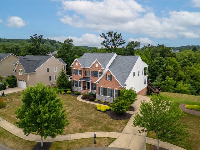 view of front of home with a front yard and a garage