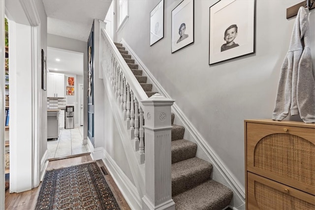 stairs with hardwood / wood-style flooring