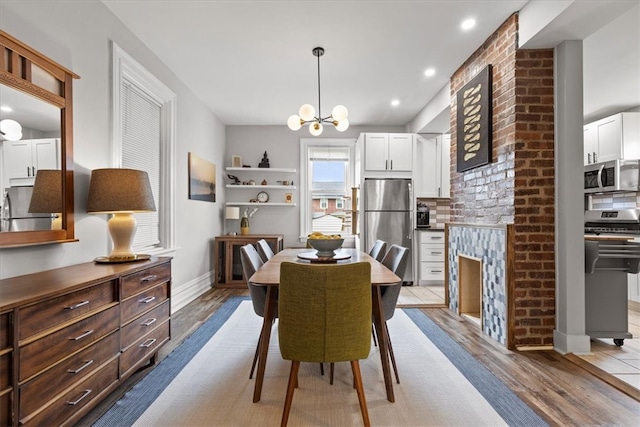 dining space with a chandelier and light wood-type flooring