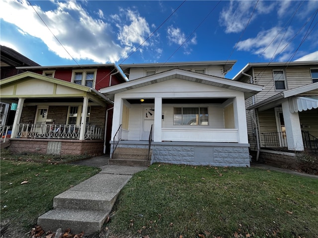 view of front of house with a porch and a front lawn