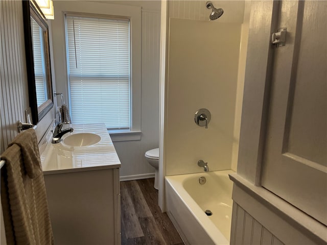 full bathroom with shower / washtub combination, hardwood / wood-style floors, vanity, and toilet