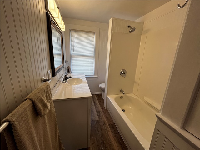 full bathroom featuring bathtub / shower combination, vanity, hardwood / wood-style floors, toilet, and plenty of natural light