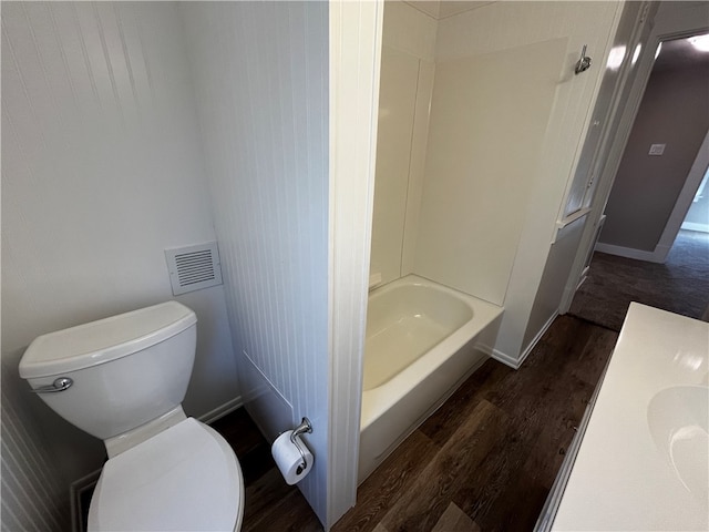 bathroom with shower / tub combination, toilet, and hardwood / wood-style flooring