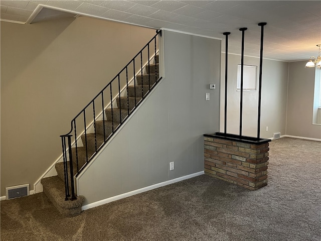 stairs with carpet flooring and a notable chandelier