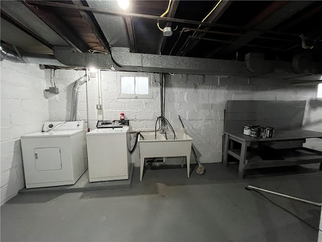 basement featuring washing machine and dryer and sink