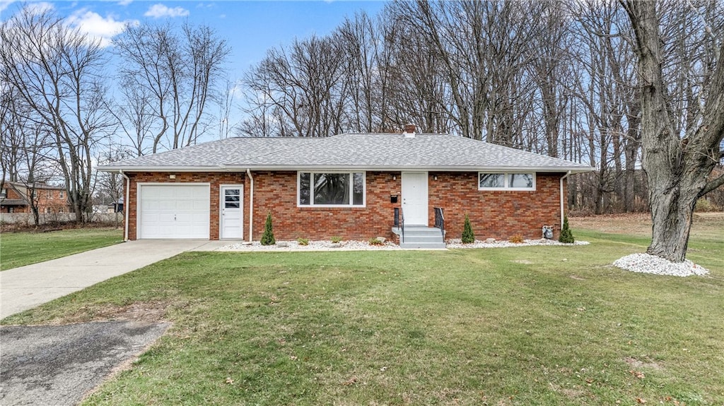 ranch-style house with a garage and a front lawn