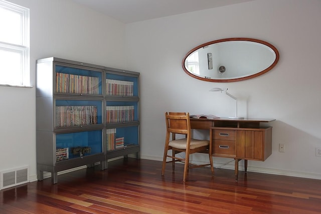 office space with dark wood-type flooring