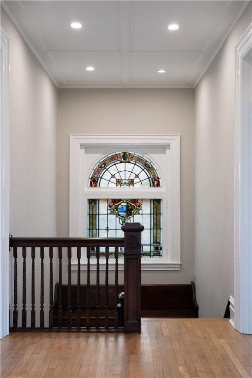 staircase featuring wood-type flooring and ornamental molding