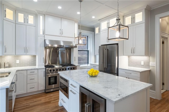 kitchen featuring white cabinetry, exhaust hood, and high end appliances