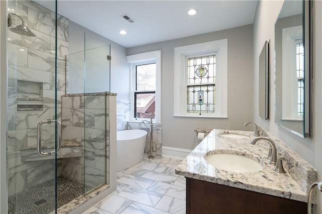 bathroom featuring vanity and independent shower and bath