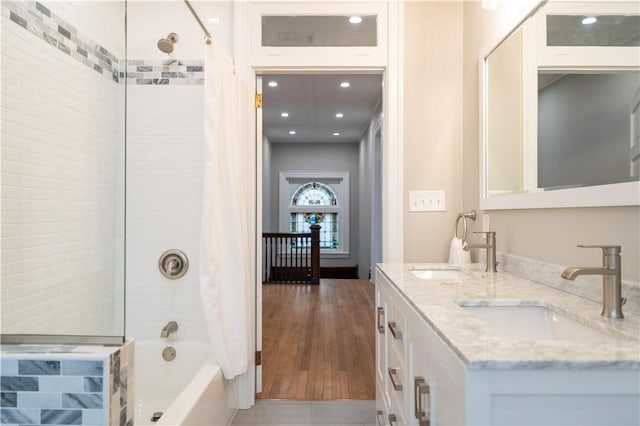 bathroom featuring hardwood / wood-style floors, vanity, and shower / tub combo with curtain