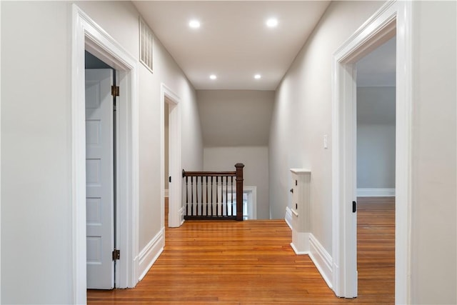 corridor with light hardwood / wood-style flooring