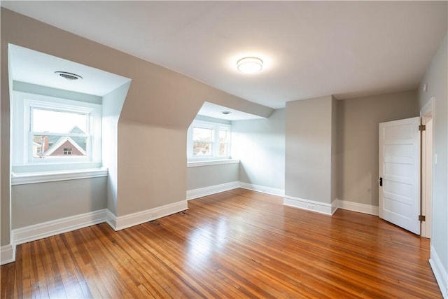 bonus room featuring hardwood / wood-style floors and a wealth of natural light