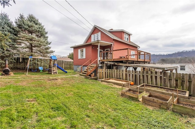 back of property featuring a playground, a deck, and a lawn