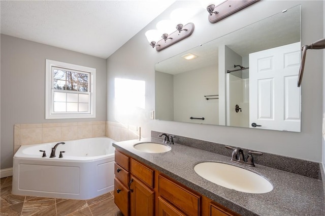 bathroom with vanity, a bath, and vaulted ceiling