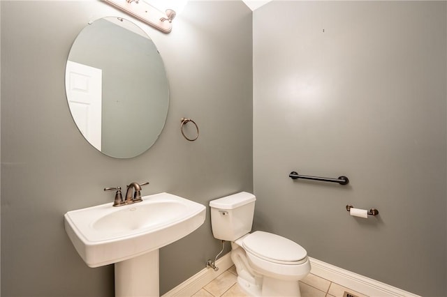 bathroom featuring toilet and tile patterned floors