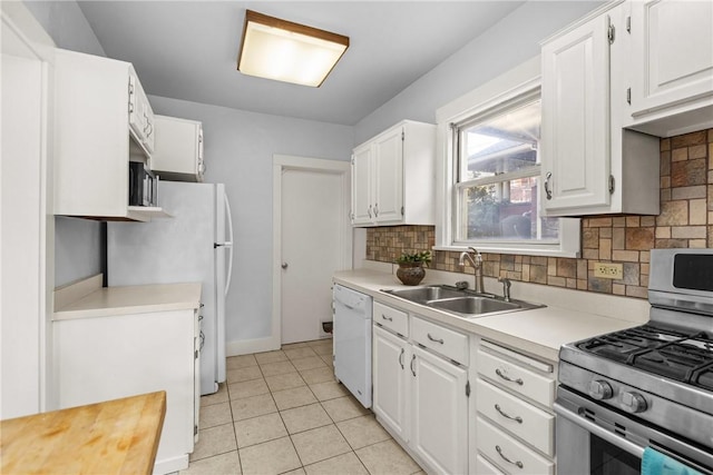 kitchen featuring decorative backsplash, sink, white cabinets, and white appliances