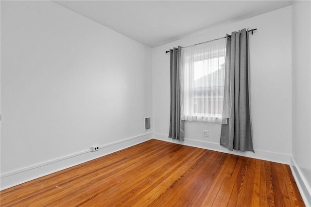 unfurnished room with wood-type flooring