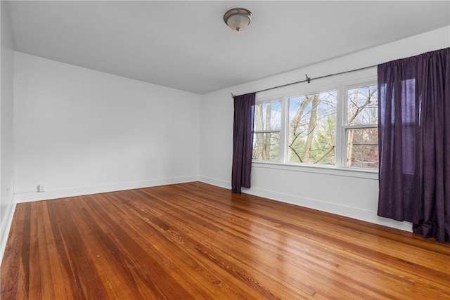 unfurnished room with wood-type flooring